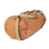 Tan duffel bag with straps on a white background