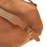Tan leather bag with a strap and buckle on a white background