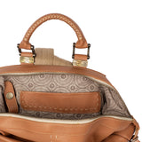 Close-up of a tan leather handbag with intricate patterns and stitching details.