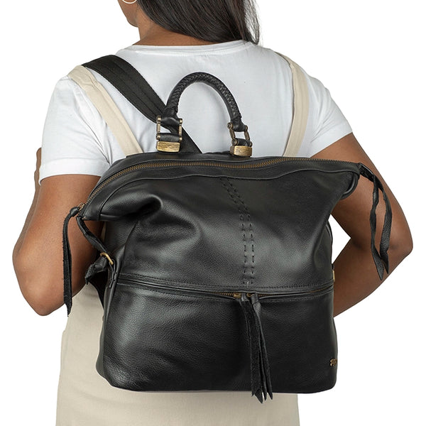 Person wearing a black leather backpack on a white background