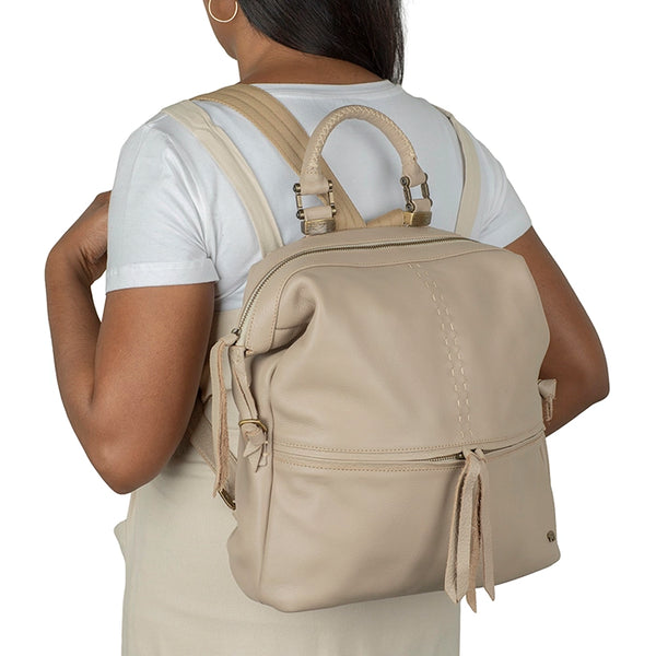 Person wearing a beige backpack on a white background