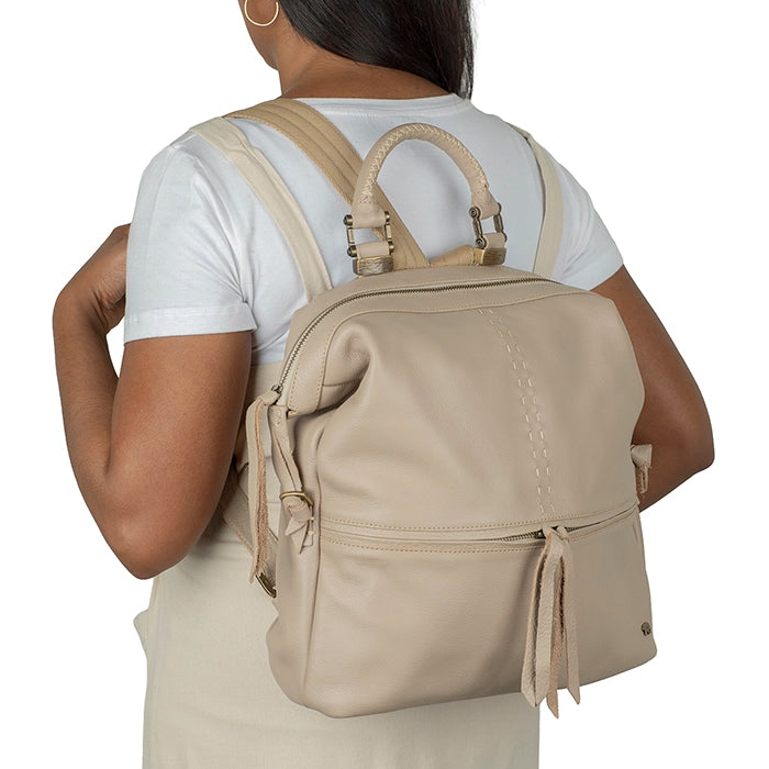 Person wearing a beige backpack on a white background