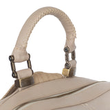 Close-up of a beige backpack handle on a white background