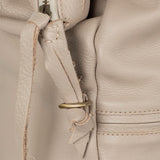 Close-up of a beige leather bag with stitching details