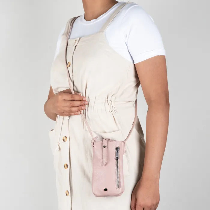 Person wearing a pink crossbody bag.
